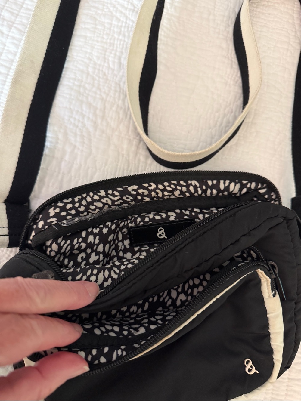 Black Quilted Crossbody Bag with Cream-Trim Strap and Subtle Logo